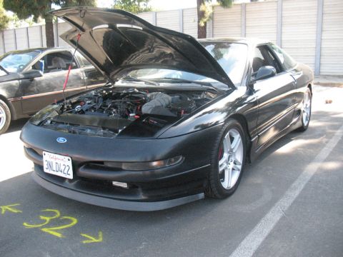 1995 Ford Probe - A black Ford Probe is parked with its hood open, revealing the engine compartment.