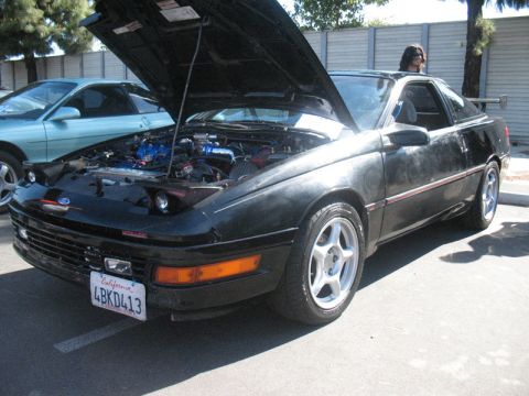 1995 Ford Probe - Black 1995 Ford Probe with hood open, parked next to a blue Probe.