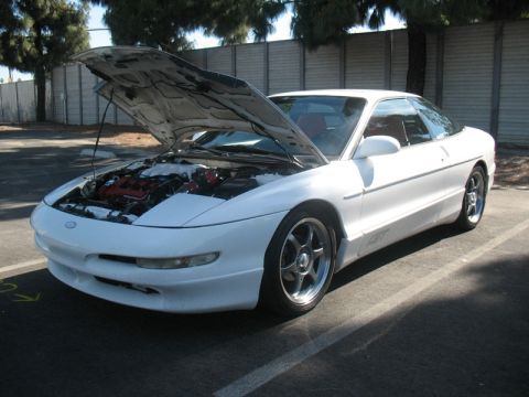 1995 Ford Probe - This 1995 Ford Probe is shown with its hood open, revealing the engine and a glimpse of the interior.
