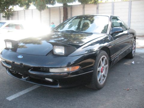 1995 Ford Probe - Front view of a black 1995 Ford Probe, showing its distinctive pop-up headlights.