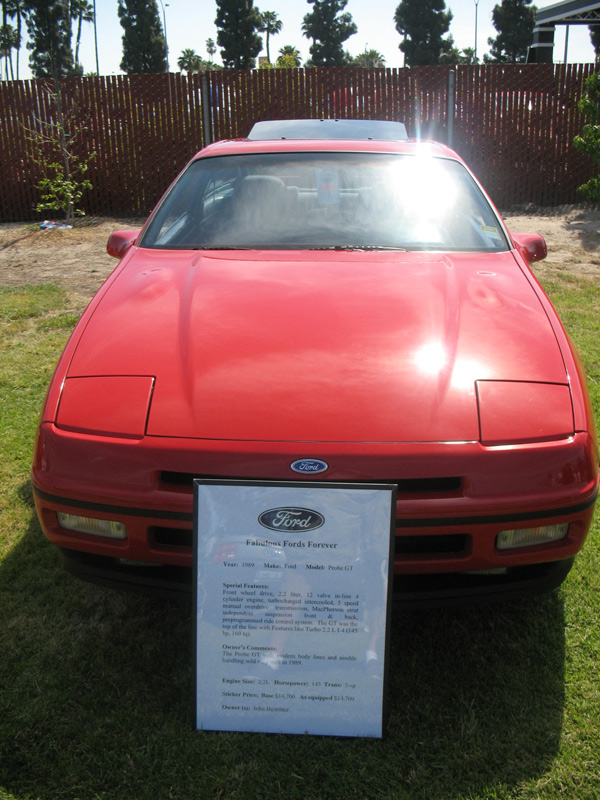 Red Ford Probe GT front view at a car show with Fabulous Fords Forever placard