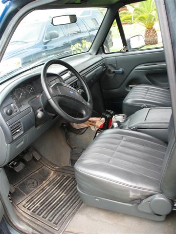 1992 Ford Bronco - Interior view of a 1992 Ford Bronco, showing the driver's side dashboard, seats, and steering wheel.