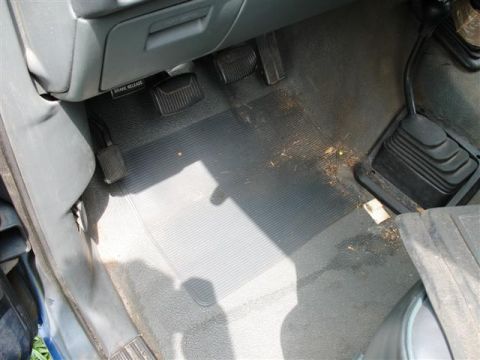 1992 Ford Bronco - Interior view of a 1992 Ford Bronco, highlighting the driver's side floor area with pedals and the gear shifter.