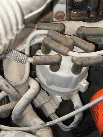 1992 Ford Bronco - Close-up view of a vehicle's distributor cap and spark plug wires.