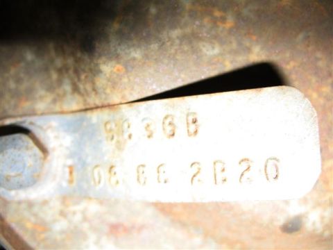 1992 Ford Bronco - A metal tag with stamped alphanumeric characters is shown, with visible rust and wear.