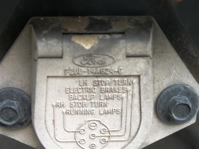Close-up of a Ford trailer connector with wiring diagram and part number F2UB-14A624-C