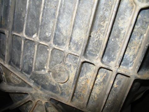 1992 Ford Bronco - A close-up view shows a cast metal part with embossed text. The text reads "13-56-039-908" and "TTC".