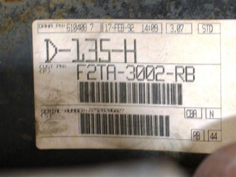 1992 Ford Bronco - A close-up of a label with text and a barcode, likely indicating a part number or identification.