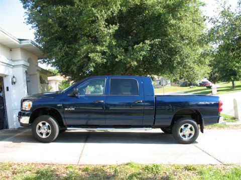 2008 Dodge 1500 - This 2008 Dodge 1500 SXT pickup truck is seen from the side, parked in a driveway.