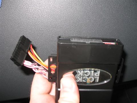 2008 Dodge 1500 - Plug wire harness adapter into LockPick device. Red area are toggle switches that can be used to turn on/off radio features.