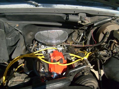 1987 Ford Bronco - Engine bay details, including a chrome air cleaner and a red distributor cap, are visible in this image.
