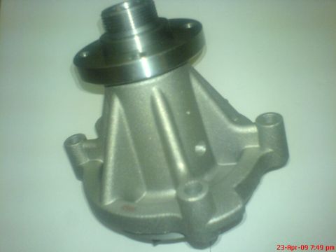 1992 Ford Crown Victoria - A silver automotive water pump is shown in a close-up, angled shot. The part features a threaded shaft at the top and a cast housing with m…