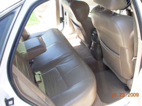 1995 Ford Taurus - Interior view of a 1995 Ford Taurus, showing the rear seating area and door panel.