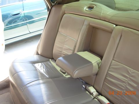 1995 Ford Taurus - Interior view of a car's tan leather seats, with another vehicle visible through the window.