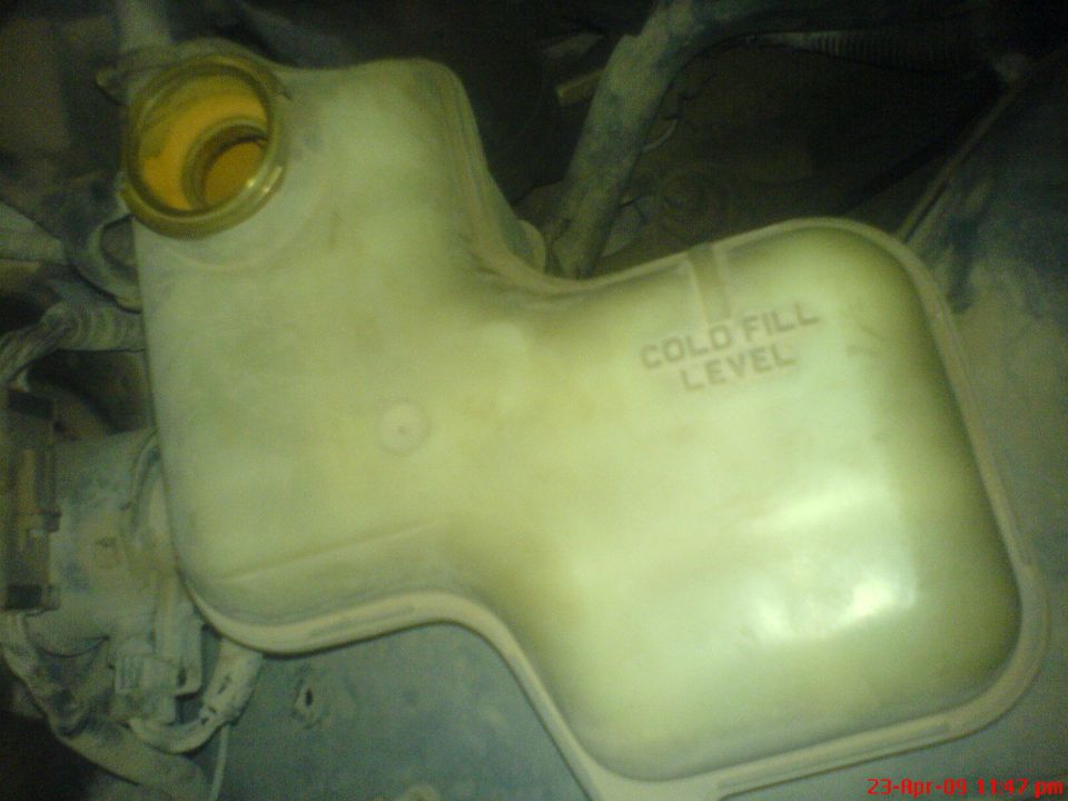 Coolant reservoir with 'COLD FILL LEVEL' text