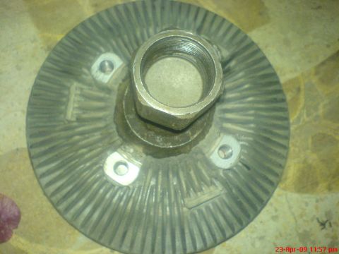 1992 Ford Crown Victoria - Close-up of a fan clutch part, likely for an older vehicle, showing its ribbed surface and central threaded hub.
