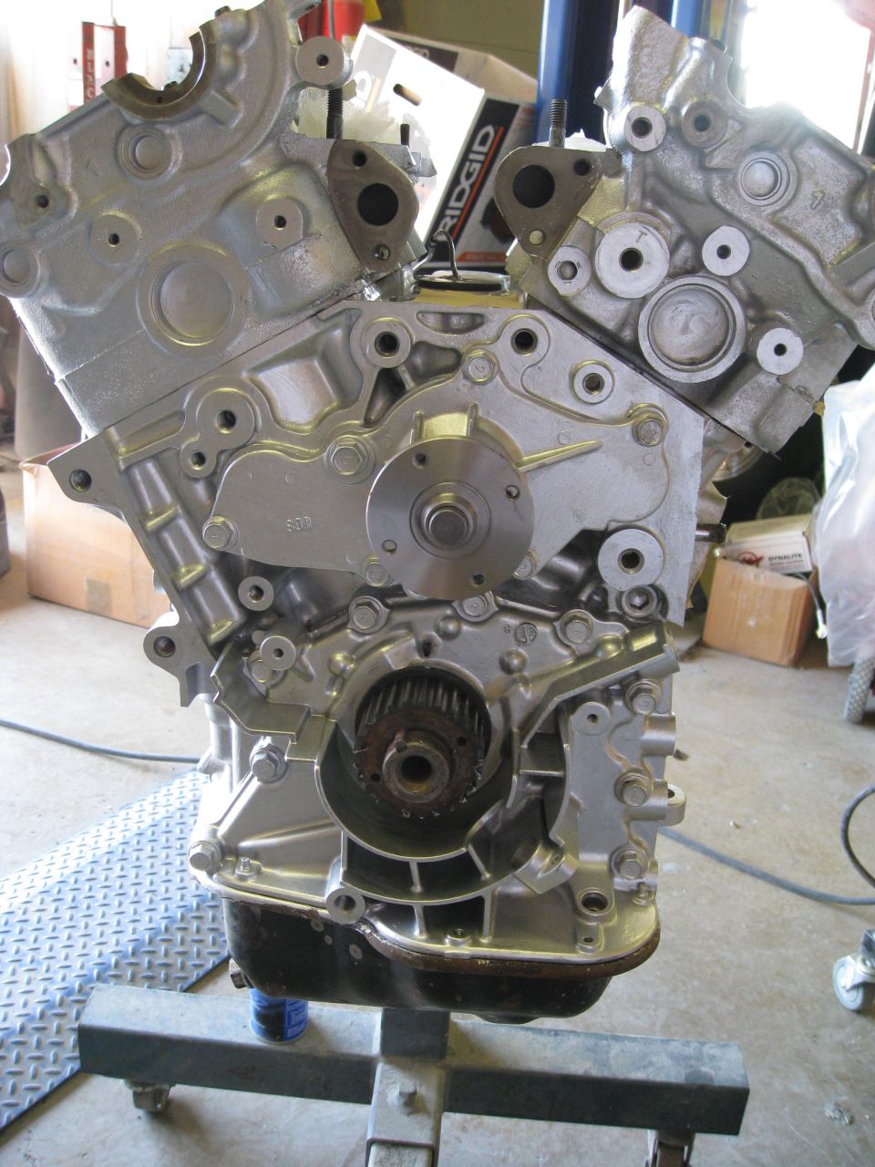 Engine block on stand, showing timing gears and water pump assembly
