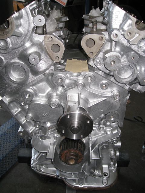 1994 Ford Probe - Close-up view of an engine block with a water pump and timing gear installed.