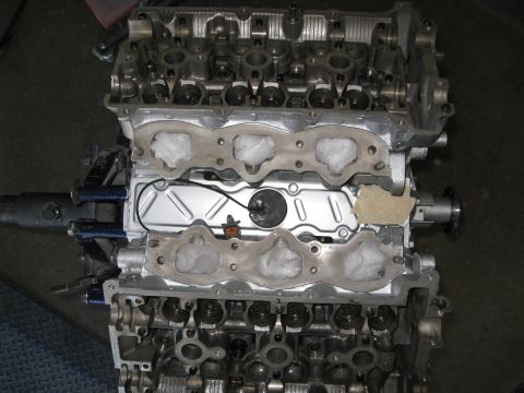 1994 Ford Probe - Engine block with intake manifold removed, revealing gasket material and wiring. The Supermotors.net logo is visible in the lower right cor…