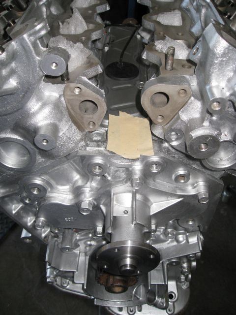1994 Ford Probe - Close-up view of a silver engine block, showing intricate metalwork and bolted components.