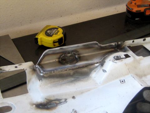1996 Ford Bronco - A close-up view of a welded metal component, with a yellow tape measure resting nearby.