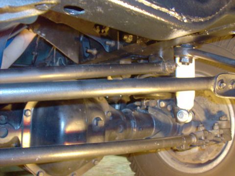 1978 Ford Bronco - Close-up of a vehicle's undercarriage, showing suspension components and a differential, with a website watermark.
