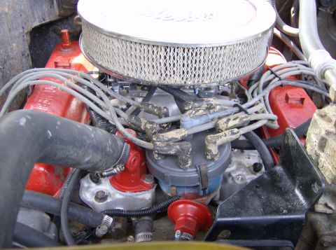 1979 Ford Bronco - Close-up view of an engine bay, focusing on the air filter and distributor assembly.