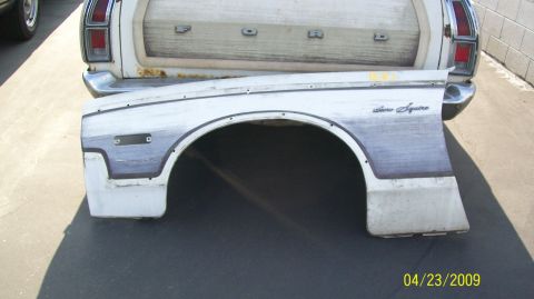 1972 Ford Ranchero - A detached rear fender from a 1972 Ford Ranchero is shown, with the vehicle's tailgate visible behind it.