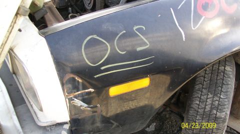 1972 Ford Ranchero - Close-up of a car's fender and wheel, showing damage and handwritten markings.