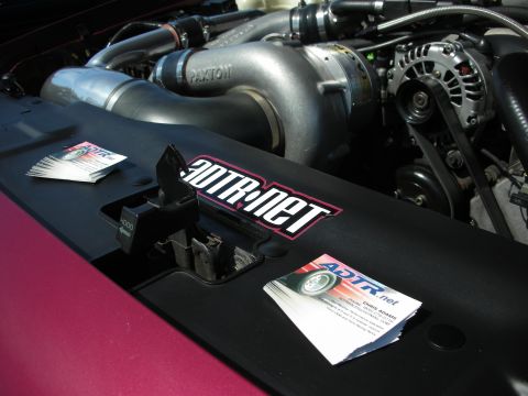 1992 Ford Crown Victoria - Close-up of a modified engine bay a Paxton supercharger and business cards from ADTR.net.