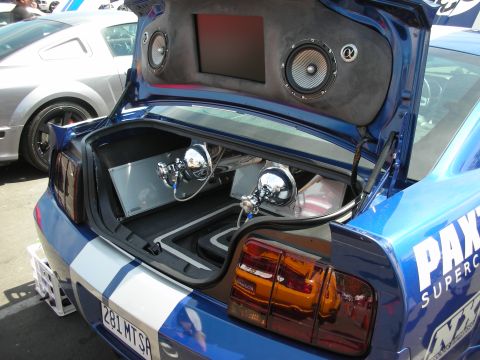 1992 Ford Crown Victoria - Modified Ford Mustang trunk displays custom audio setup and air ride components, with another Mustang visible in the background.