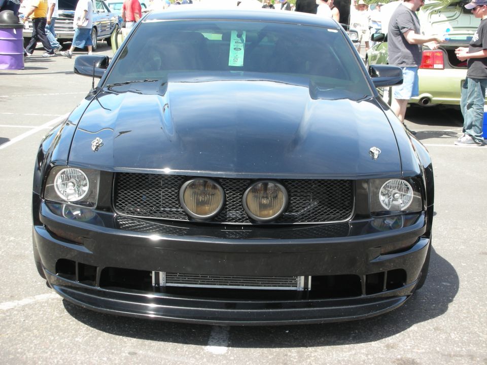 Black 2005 Ford Mustang front view with aftermarket hood and grille