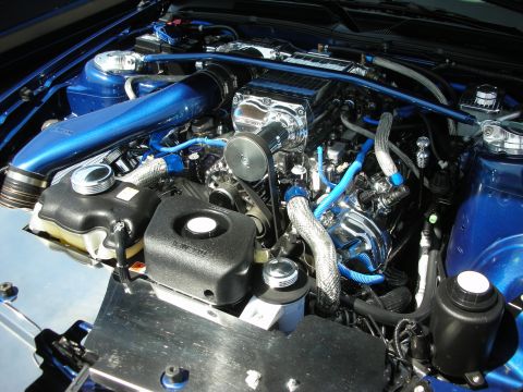 1992 Ford Crown Victoria - Customized engine bay a polished supercharger and vibrant blue components.