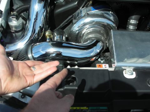 1992 Ford Crown Victoria - A person's hands are shown near a shiny supercharger and intake system, likely a custom engine modification.