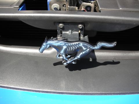 1992 Ford Crown Victoria - A close-up of the iconic Ford Mustang running horse emblem, detailed with a skeletal design.