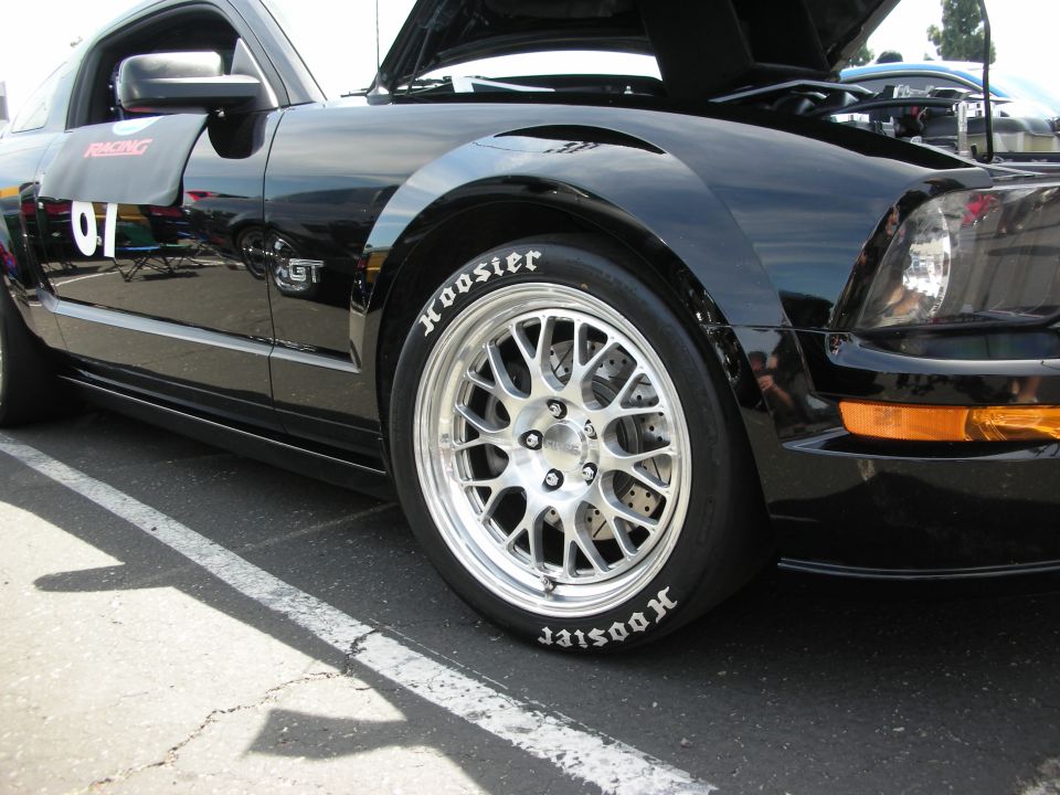 Black Ford Mustang GT with racing decals and Hoosier tires