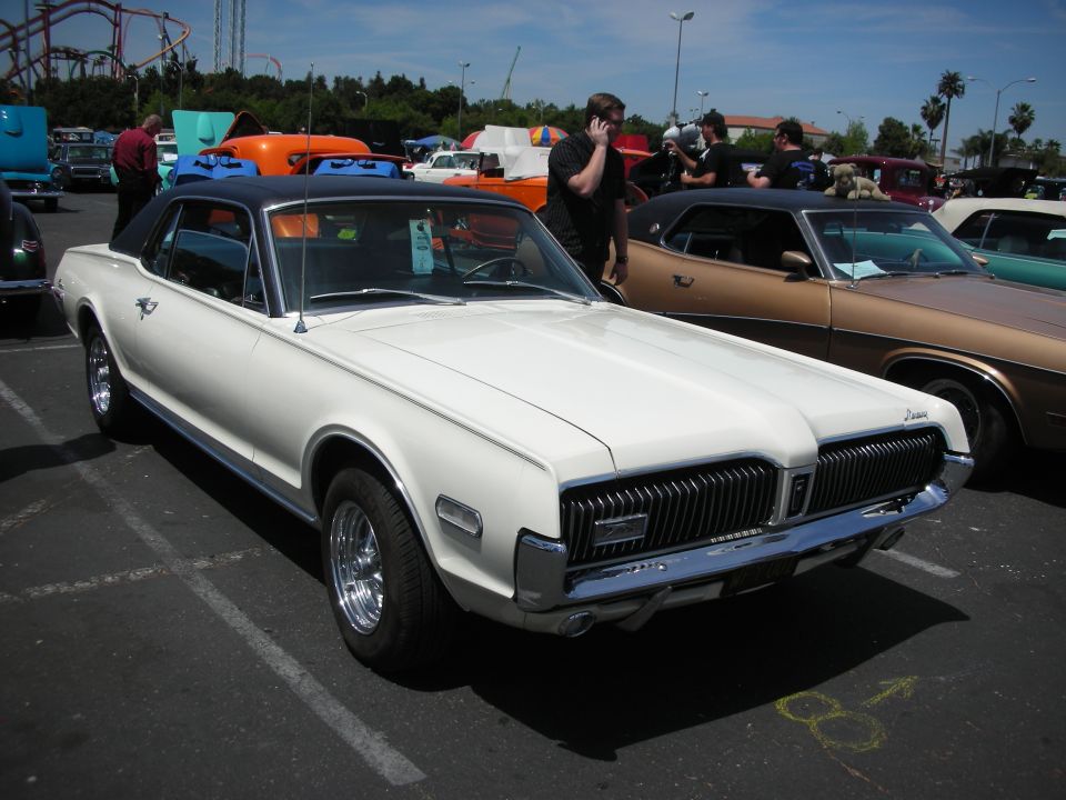 White 1968 Mercury Cougar XR-7 with black vinyl roof, front 3/4 view