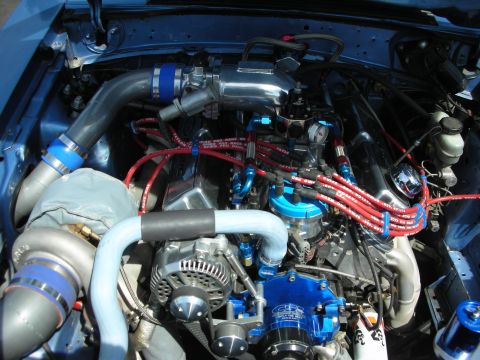 1992 Ford Crown Victoria - Close-up view of a modified engine bay, highlighting custom performance parts and vibrant colors.