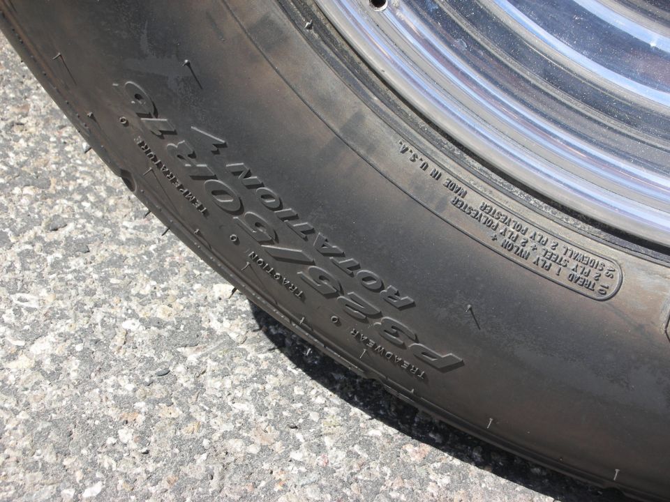 Close-up of tire sidewall with P355/50R16 size and rotation information
