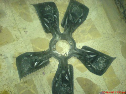 1992 Ford Crown Victoria - Fan blade part shown on a tiled floor.