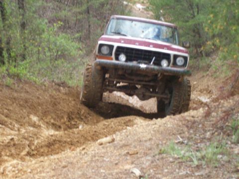 1978 Ford Bronco - This 1978 Ford Bronco is navigating a challenging off-road trail with steep inclines and loose dirt.