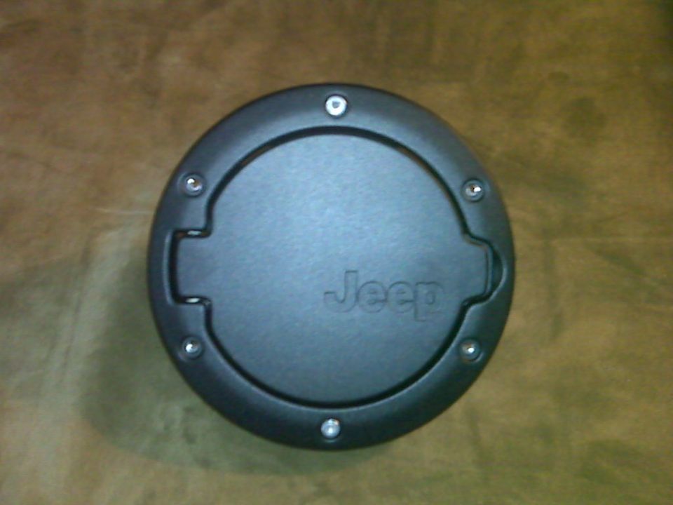 Jeep fuel filler door with screws around the edge