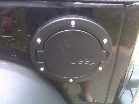 2008 Jeep Wrangler - Close-up of a black Jeep fuel filler door, showing the brand name embossed on the cover.