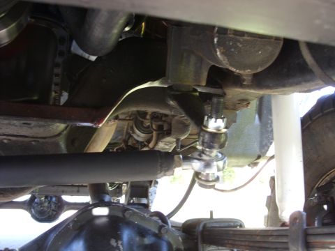 1988 Ford Bronco - Underside view of a vehicle's steering linkage system, showing mechanical components.