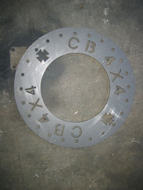 1992 Ford Mustang - Metal disc with 'CB' and '4X4' markings, likely a component part.