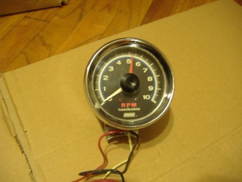 1987 Ford Crown Victoria LTD - A tachometer gauge with visible wiring sits on a cardboard surface.