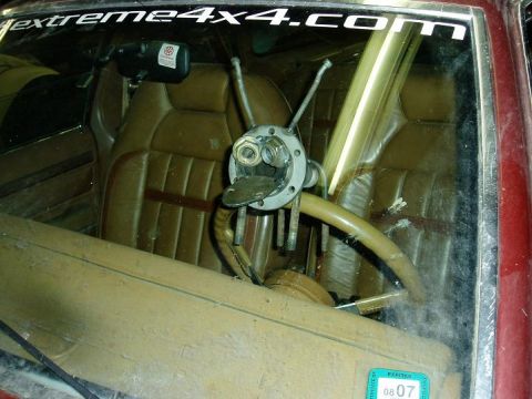 2000 Ford E350 - Interior view of a vehicle a unique, custom-built steering wheel mechanism with visible hardware.