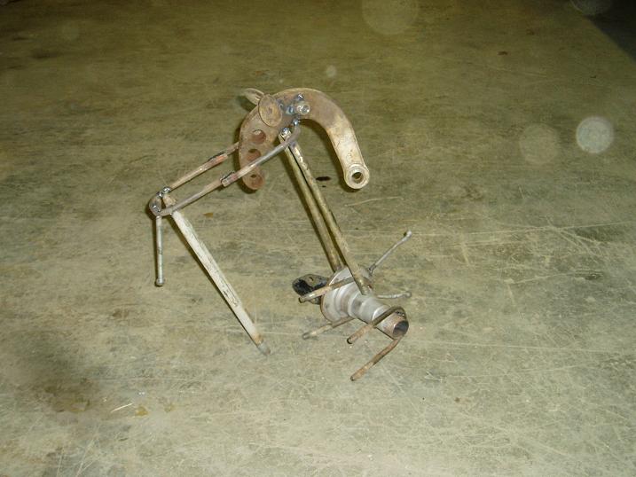 rusted metal sculpture made from various mechanical parts, resembling an insect