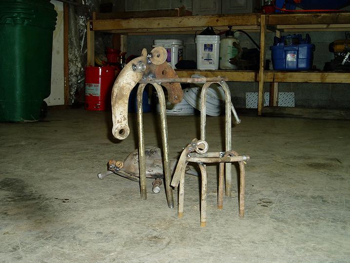 Metal sculpture made of welded parts, resembling an animal, in a garage