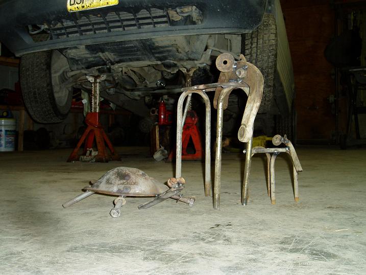 Metal turtle sculpture made from scrap parts on concrete floor.